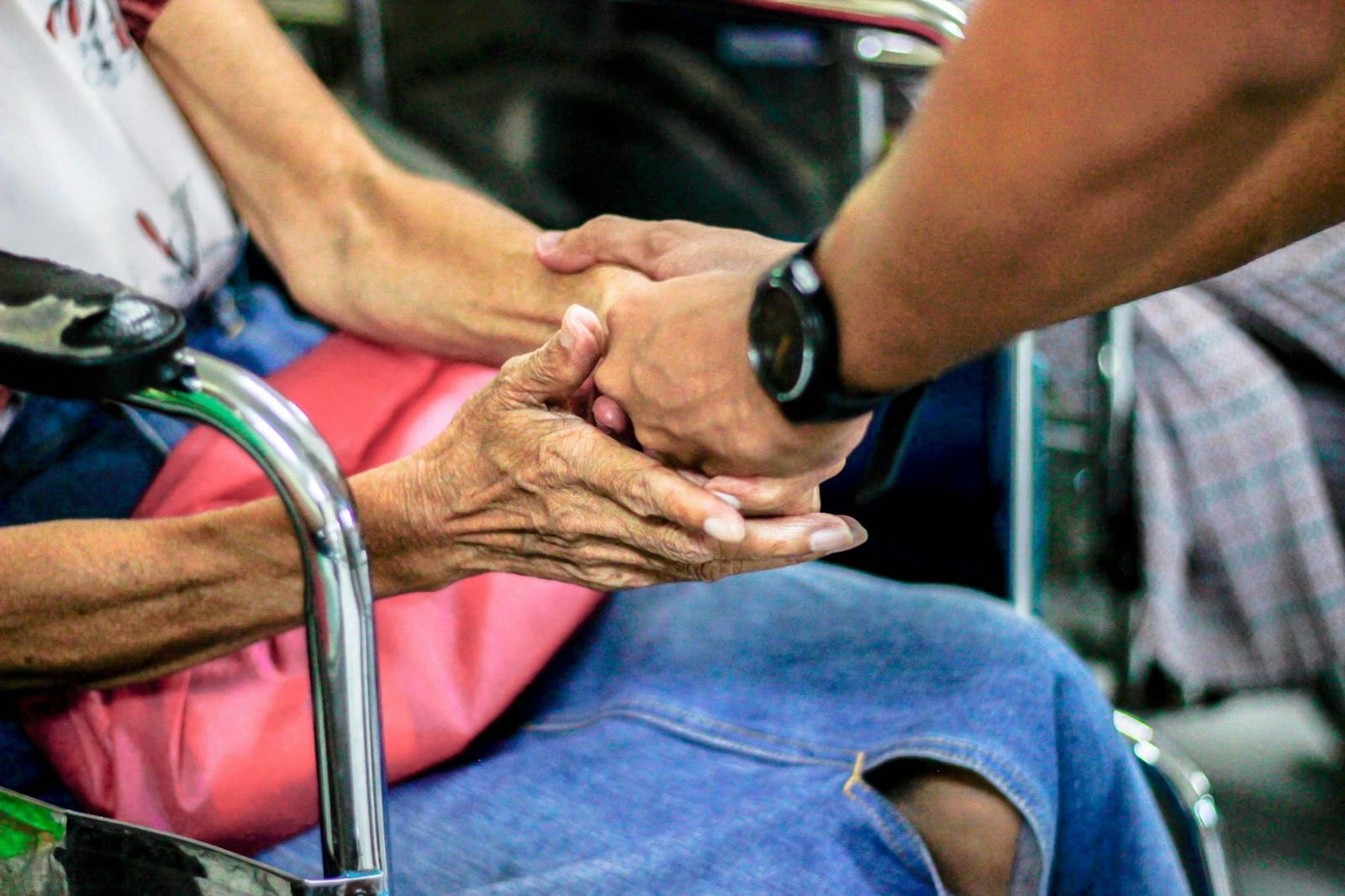 A carer holding an older person's hands