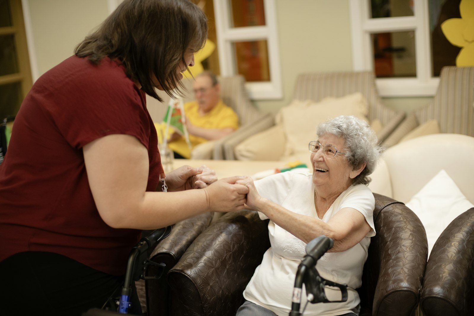 An older person trying equipment with a helper