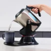 Gilia tipping kettle on its swivel base, BPA-free plastic and stainless steel